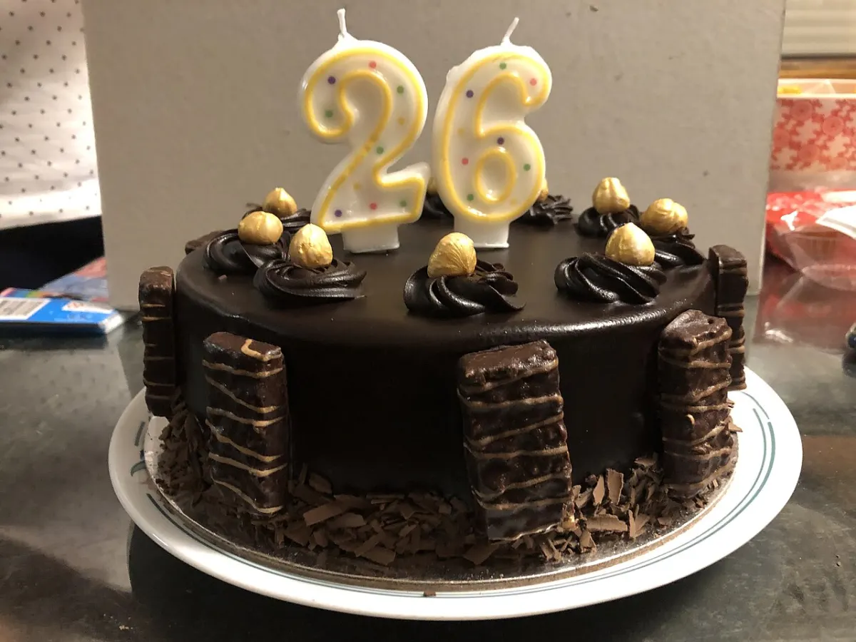 Age Calculator App - Tim Tams and Nuts on a Birthday Cake With Candles