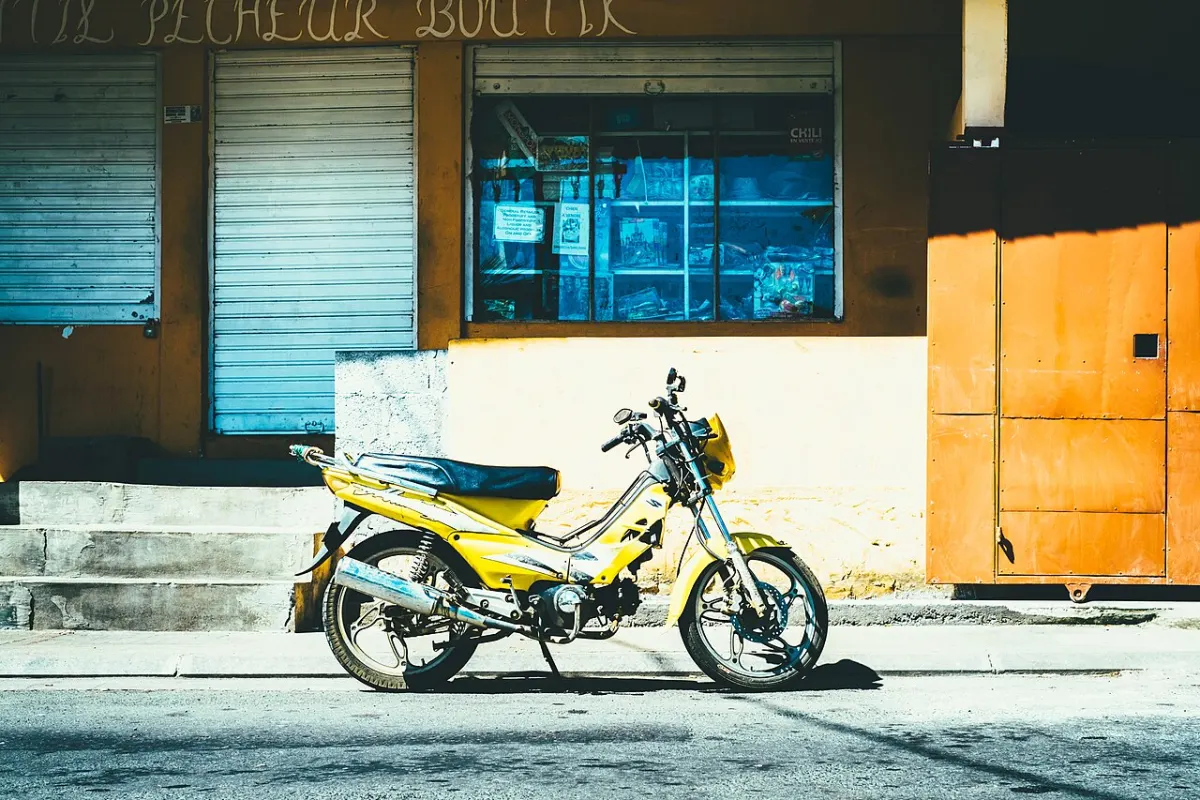 Anti-Theft Vehicle System - Yellow motorcycle parked (Unsplash)