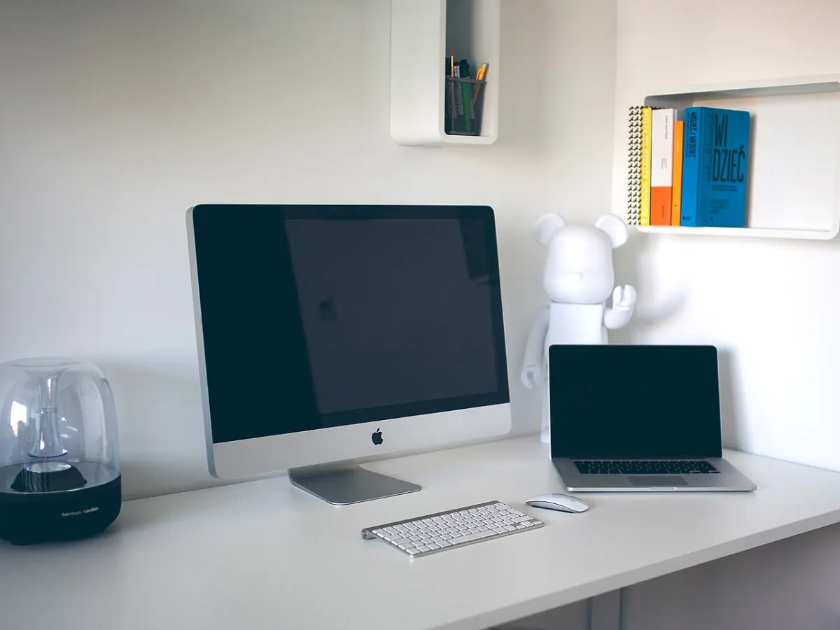Asset Management System - An office table and computers (Unsplash)