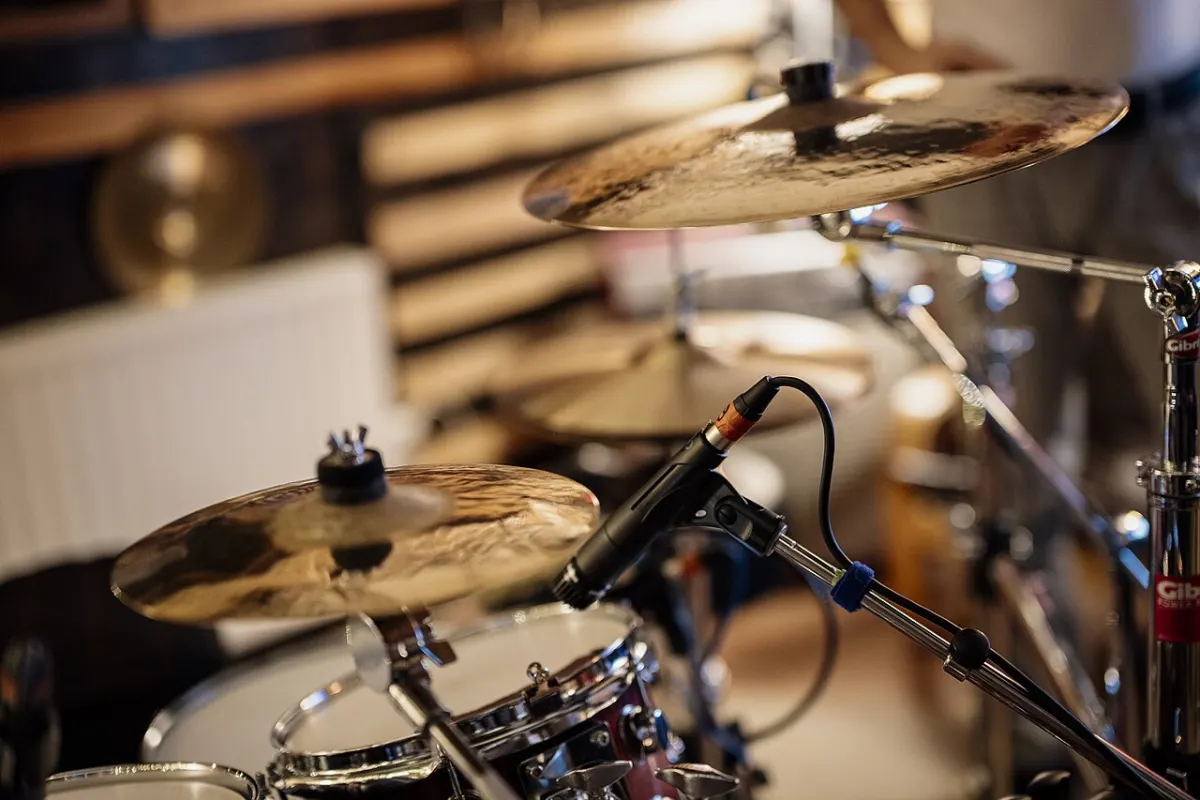 Audio Recorder Software - Drum set ready for practice in a music studio with microphone and cymbals