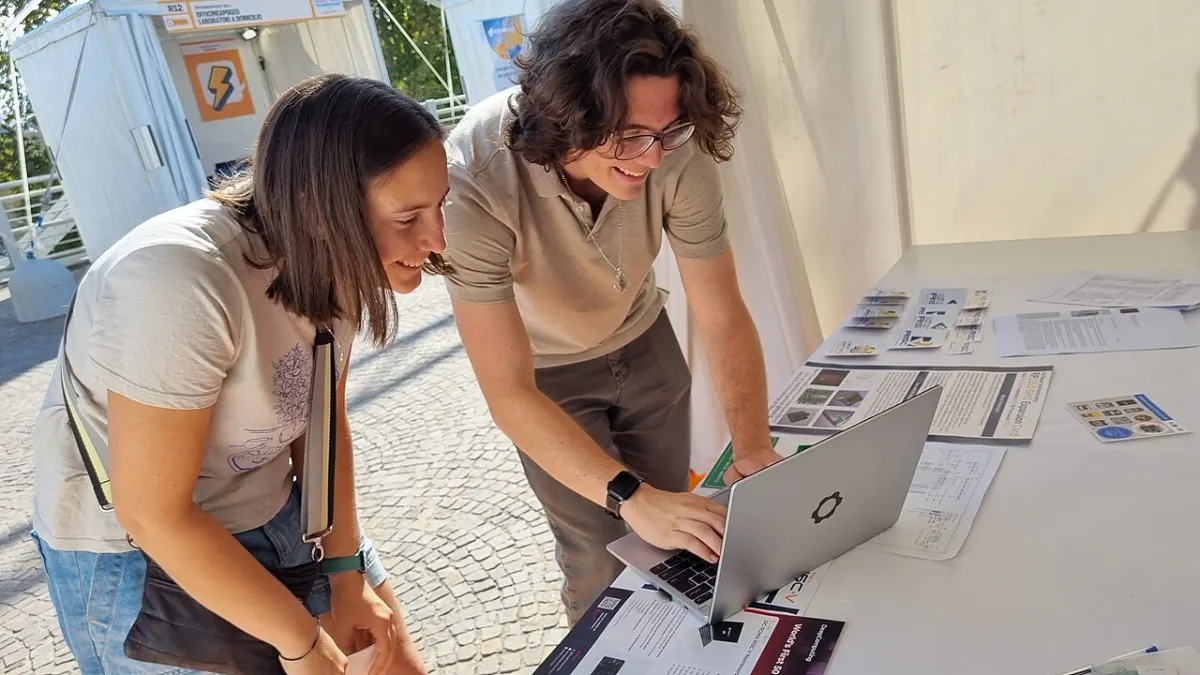 Blogging Platform - 2 people using Framework Laptop 13 with DC-ROMA RISC-V Mainboard inside, at Maker Faire Ro