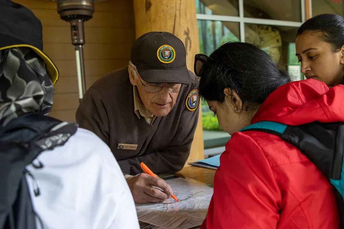 Charity Management System - A volunteer helping visitors