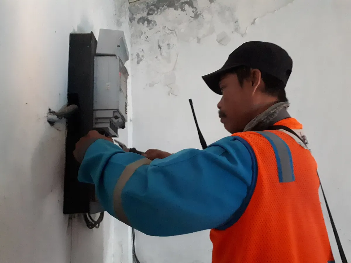 Electricity Billing Management System - Electricians fixing electricity meter 5