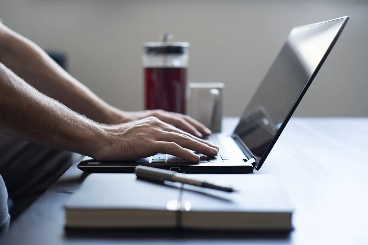 Freelancing Marketplace - Working from home laptop and notepad