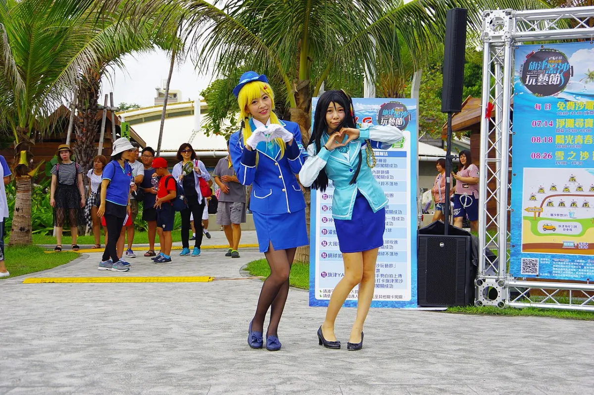 Gesture Recognition System - Amelia and Sora cosplayers giving heart hand gesture at Cijin Black Sand Festival