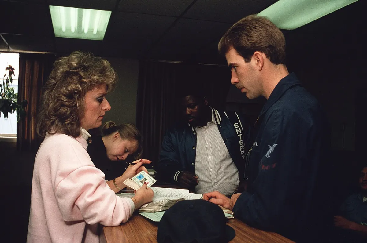 Helpdesk Management System - A civilian employee of the air station's Personnel Support Detachment waits on a sailor at