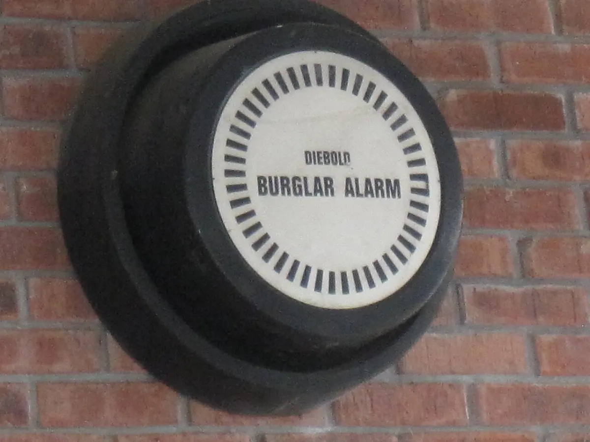 Home Security Alarm System - Diebold burglar alarm on the outside of a brick building
