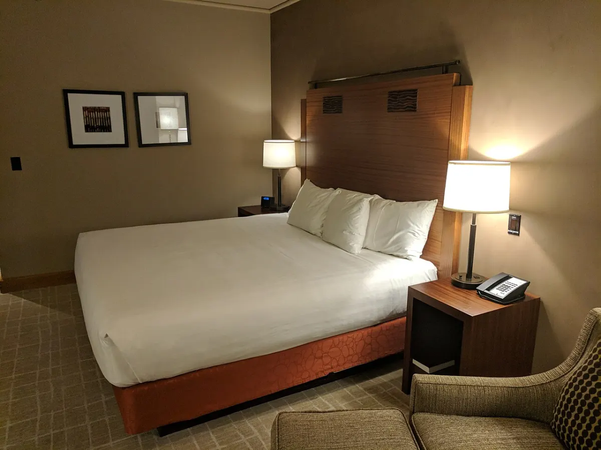 Hotel Management System - Bed in hotel room 5