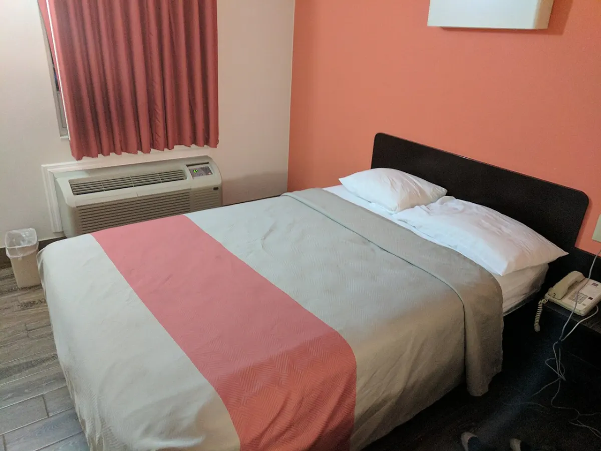 Hotel Management System - Bed in hotel room 4