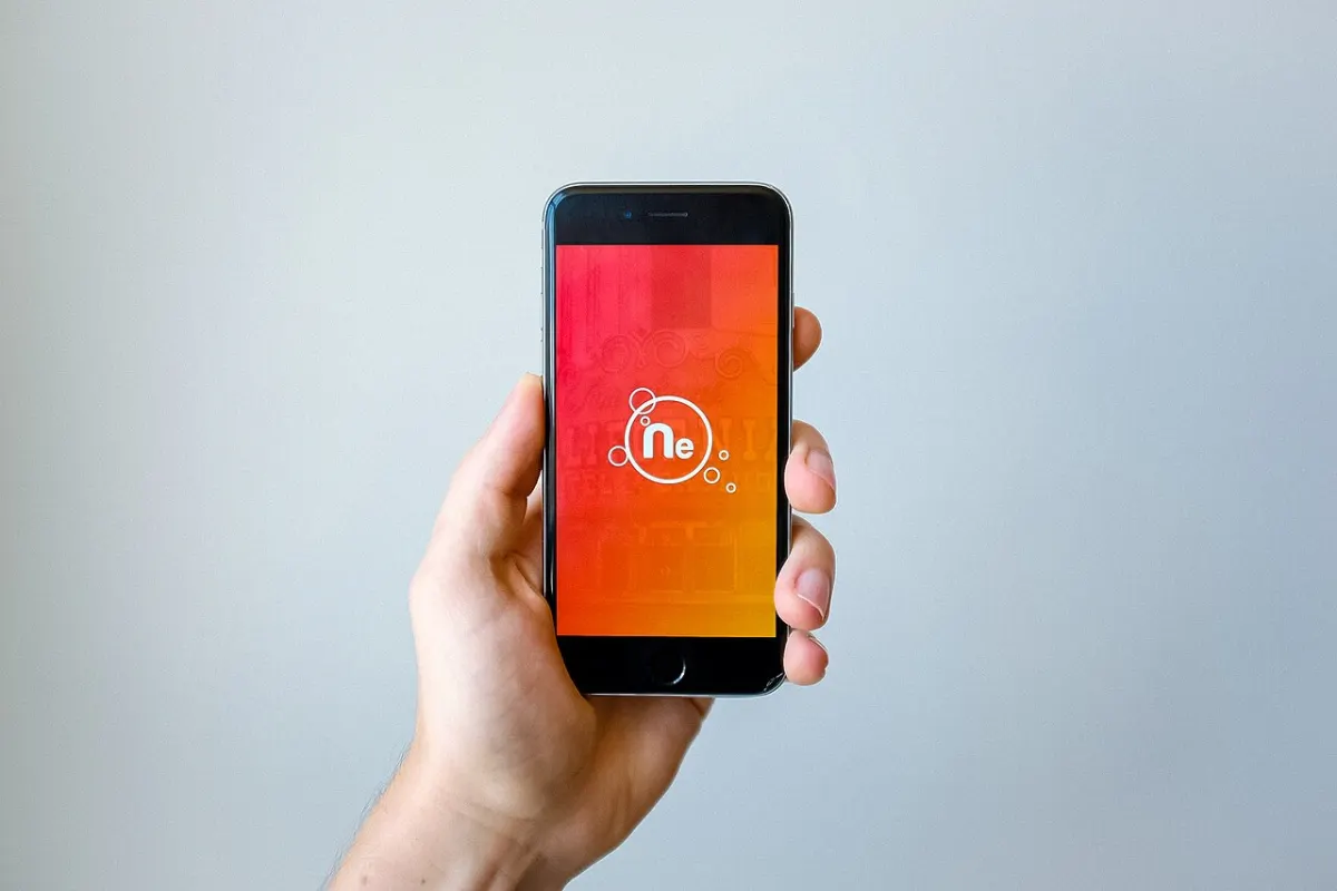 Live Location Tracker App - Smartphone in Hand (Unsplash)