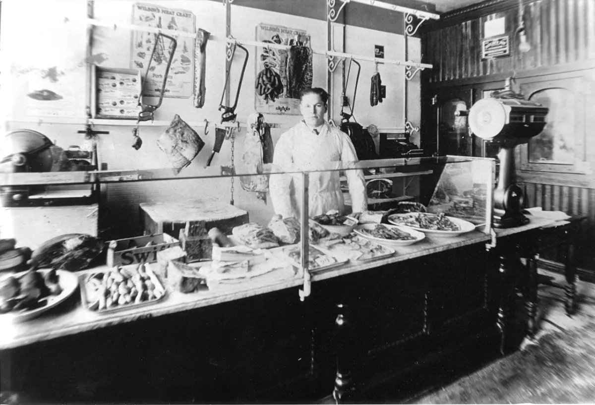 Meat Shop Management System - Butcher shop-John Igel, butcher behind counter, Minneapolis, MN, ca. 1923