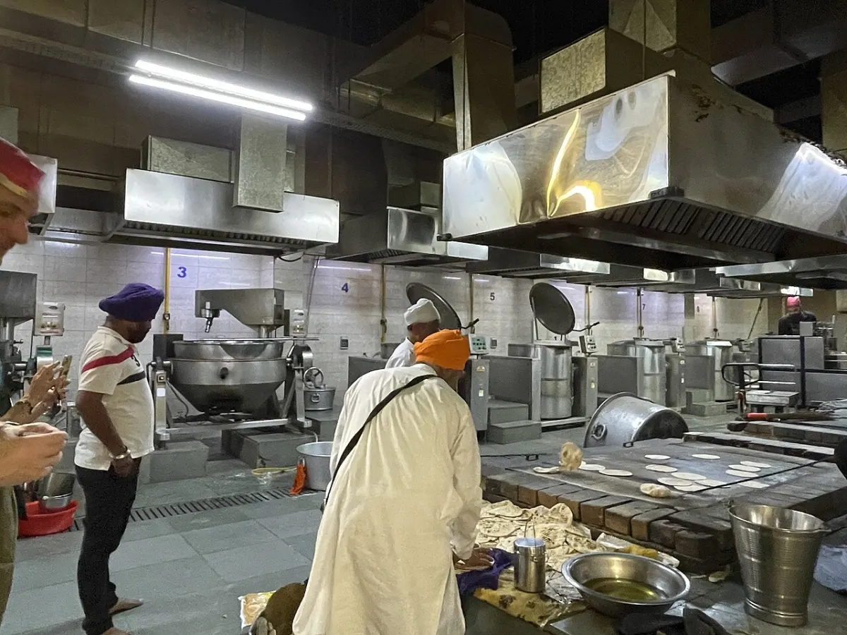 Recipe Sharing Website - Sikh volunteers cooking food at Gurdwara Bangla Sahib kitchen