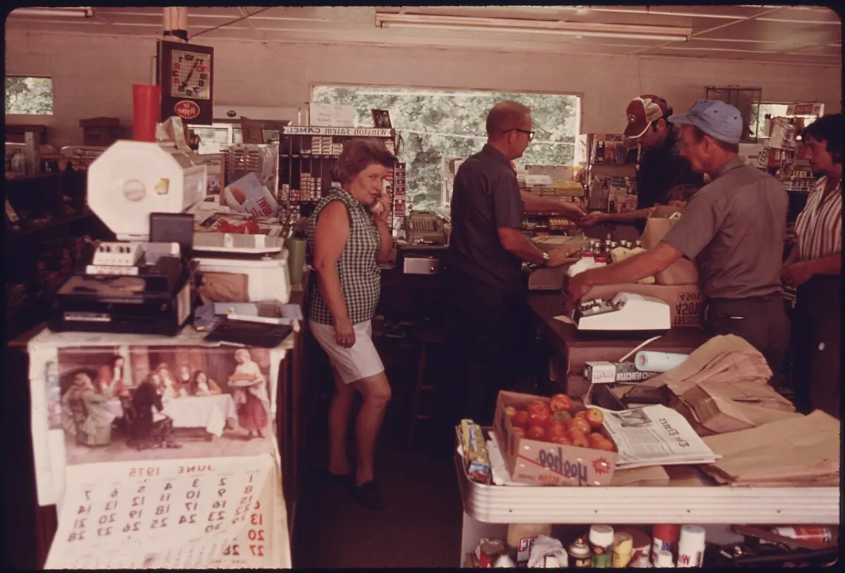Retail Shop Billing Software - MR. AND MRS. H.C. JOHNSON BEHIND THE COUNTER WAIT ON CUSTOMERS IN THE GROCERY STORE THE CO