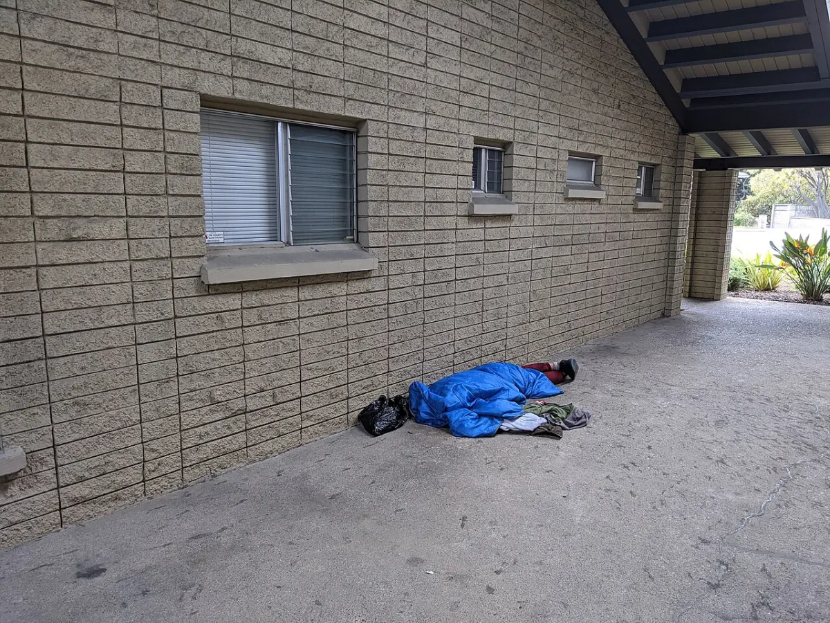 Sleep Monitoring Wearable - Homeless person sleeping outside office building in San Jose