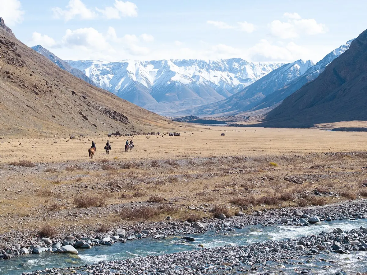Tour & Travel Management System - Tourists travel by horseback in Sarychat-Ertash Nature Reserve