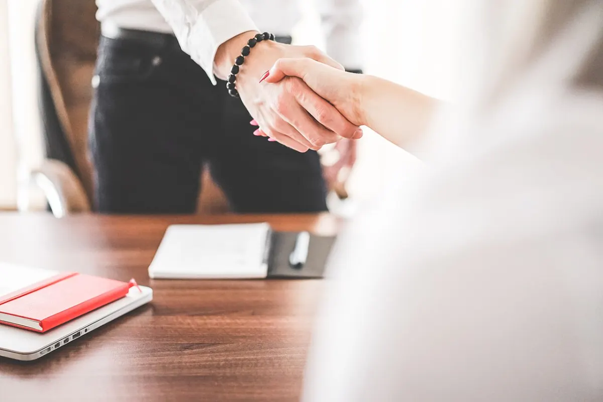 Vendor Management System - Business man and woman handshake in work office